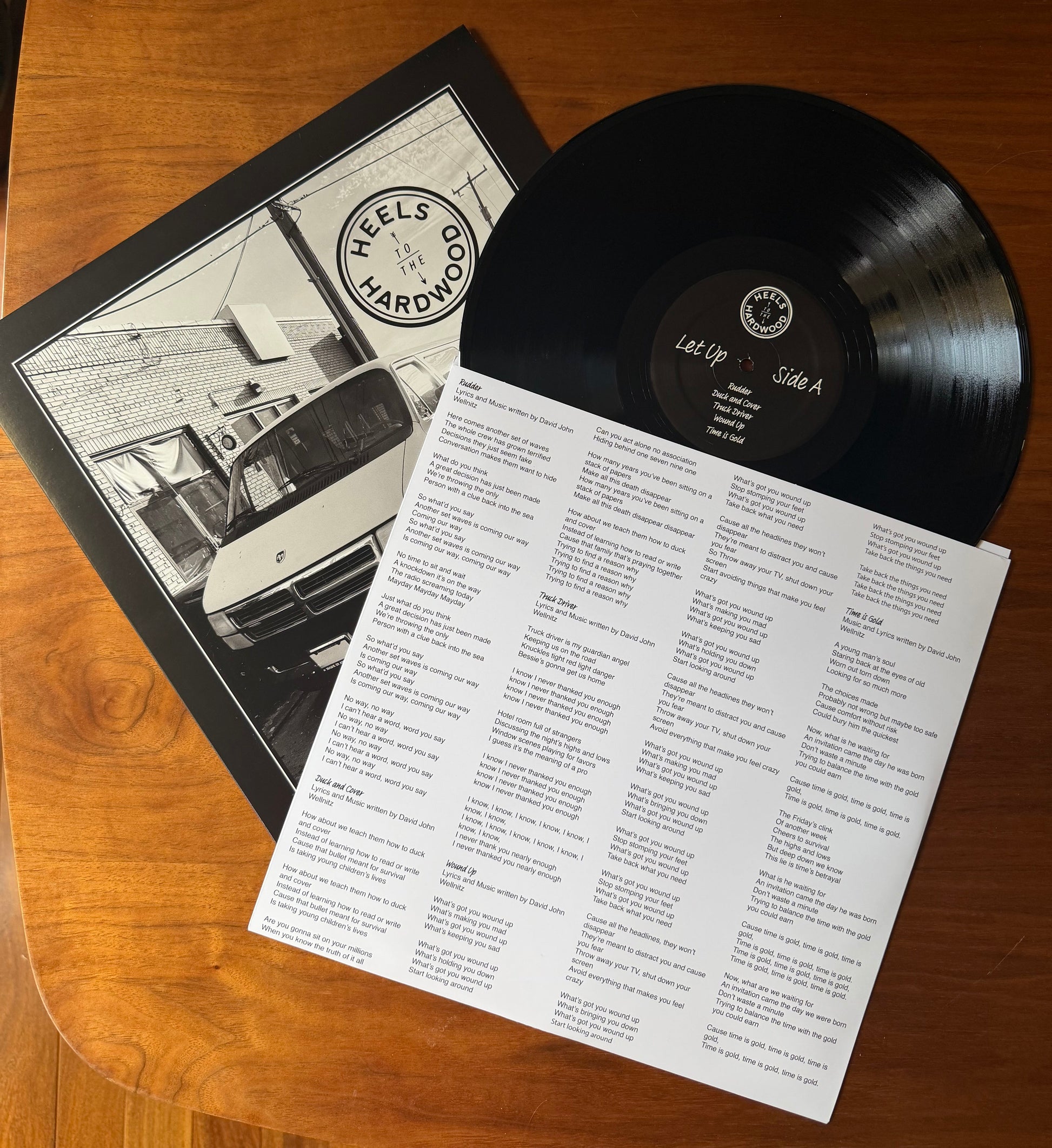 Vinyl record with a menu on a wooden surface